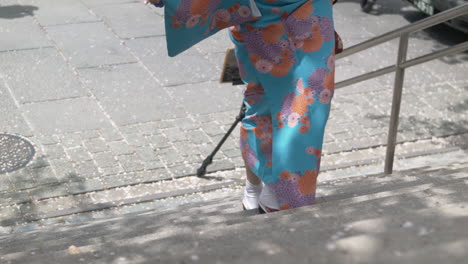 woman in beautiful blue kimono walking up stairs (50p)