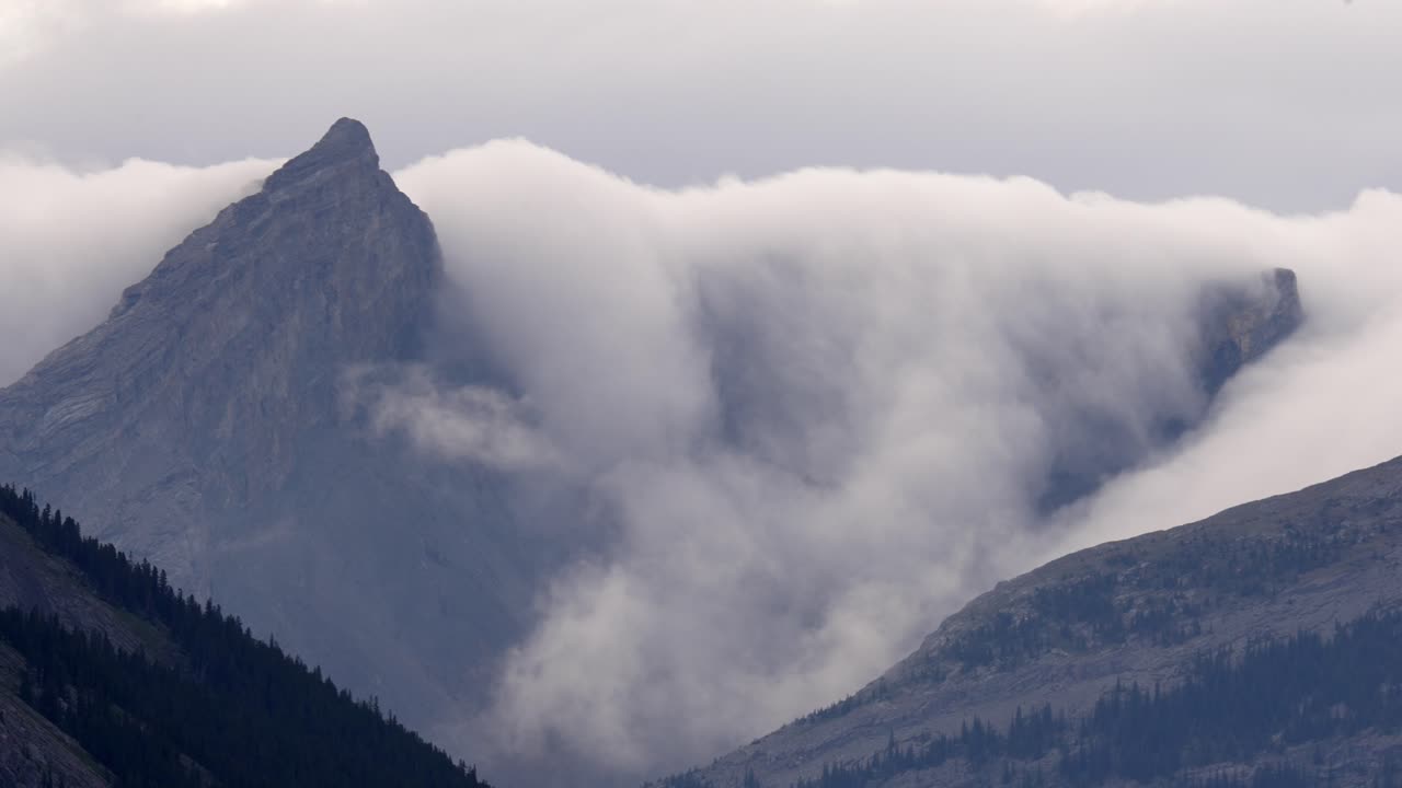 timelapse of major clouds rolling over mountain in kananaskis rocky mountains.