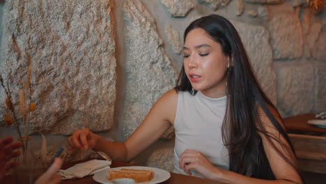 woman eating cake in a cafe