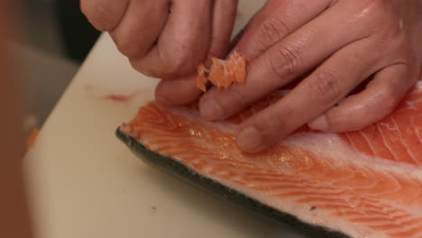 Remove-Pin-Bones-From-An-Uncooked-Salmon-Meat-Using-Tweezer