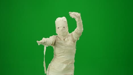 scary Mummy Wrapped in Bandages Dances Wearing a Black Hat and Sunglasses Green Screen Isolated Scary Mummy Wrapped in Bandages Dances Wearing a Black Hat and Sunglasses Green Screen Chroma Key Mock up Workspace for your Promotion Clip or Advertisement Medium Size Halloween Holidays
