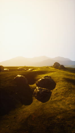 sunset over grassy hills