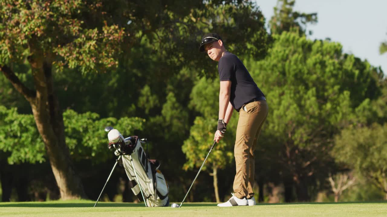 Video of caucasian man playing golf on golf field