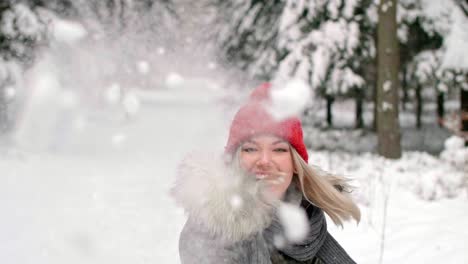 girl throwing snowball right on the camera