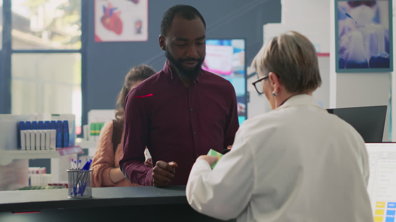 Customer interacting with pharmacist at pharmacy counter