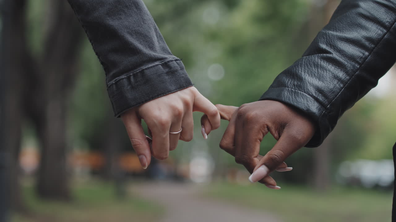 Close Up of Women Holding Pinkies