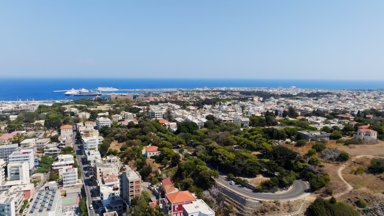 Panoramic drone shot overlooking the cityscape of Rhodes city, in sunny Greece