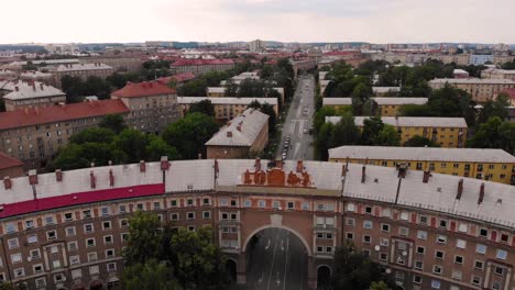 Oblouk-building-aerial-tilt-up-fly-backward-drone-shot