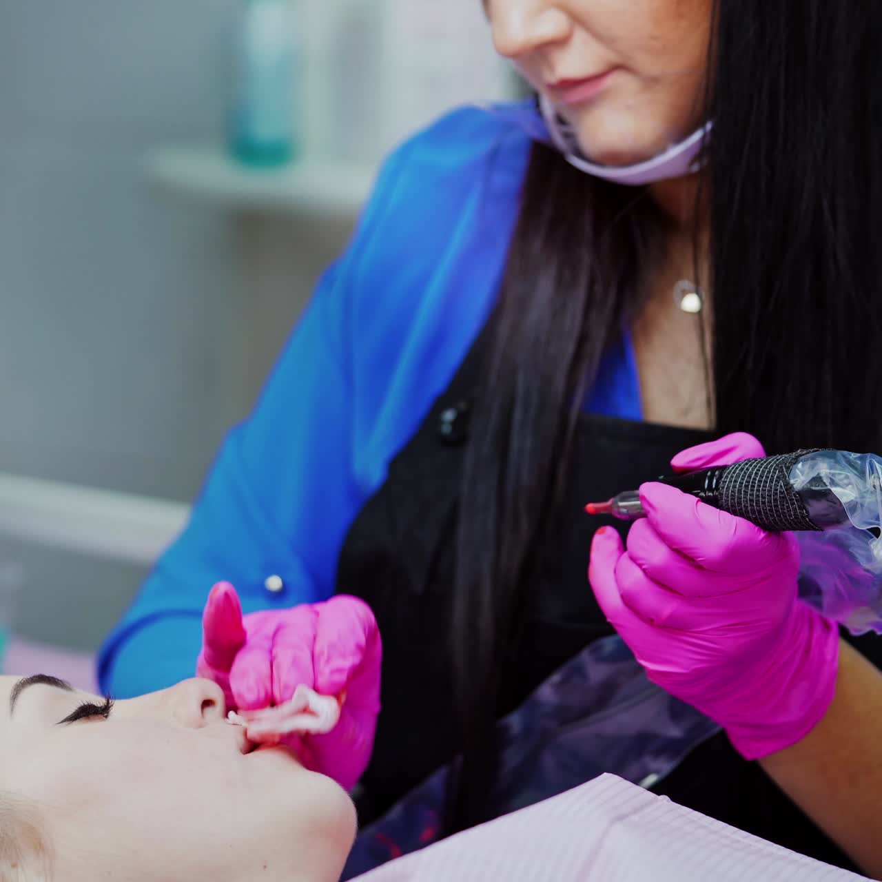 Cosmetologist making permanent makeup