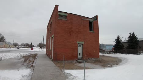 an old abandoned brick building in a small town during the winter near alberta canada