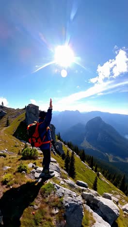 hiker on a mountain top with a view of lake