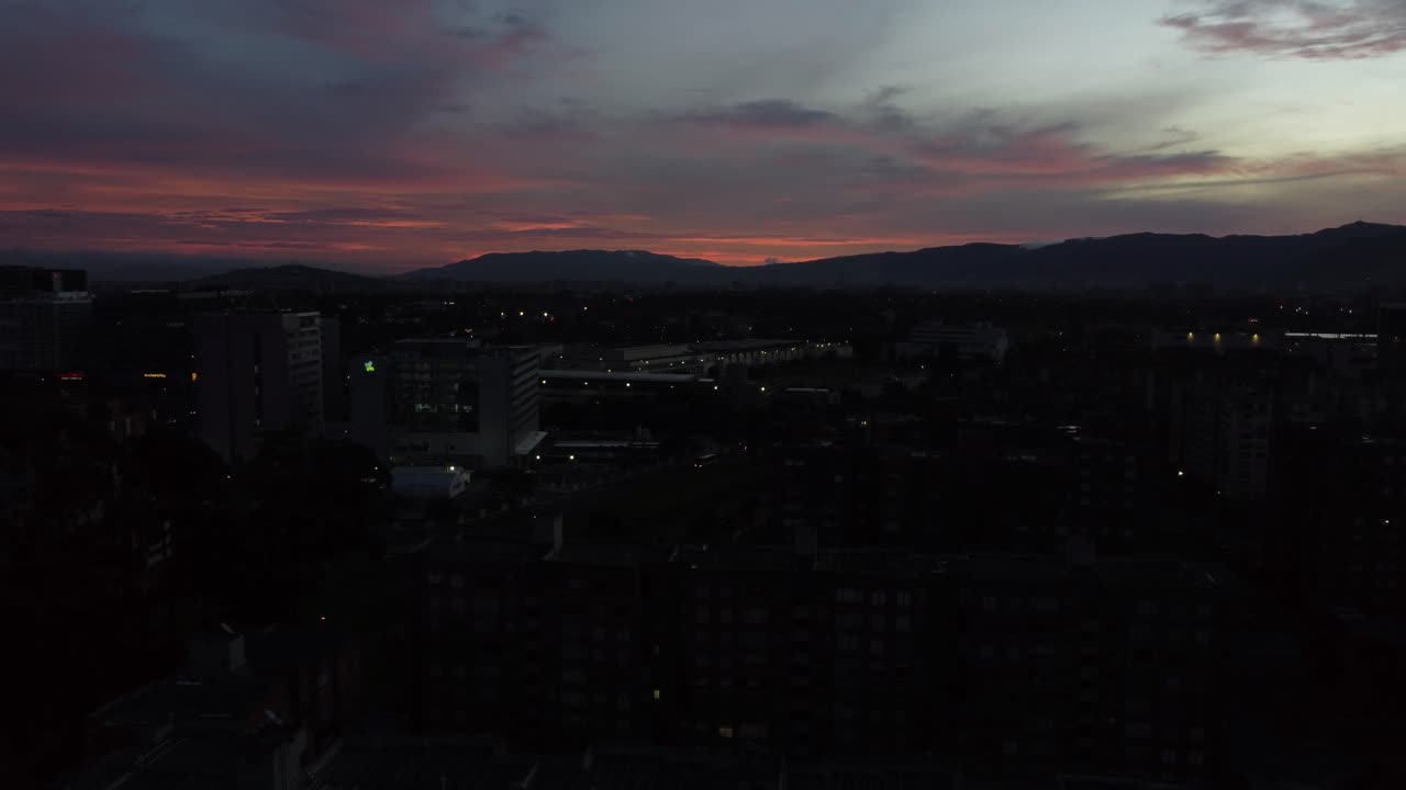 Sunset over City with Mountains in the Background