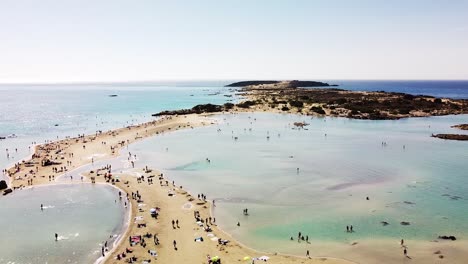 Many-tourist-enjoys-hot-day-on-Elafonissi-beach,-aerial-view