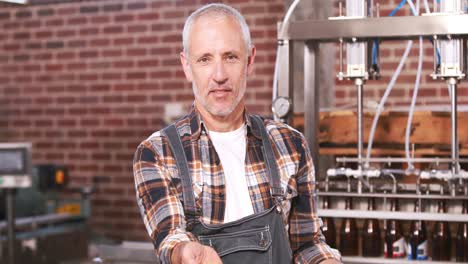 smiling brewery worker explaining different seeds