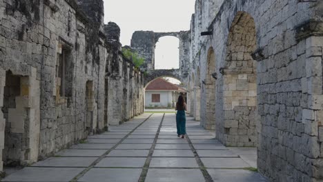 tourist walking through the cuartel ruins of oslob on the island of cebu