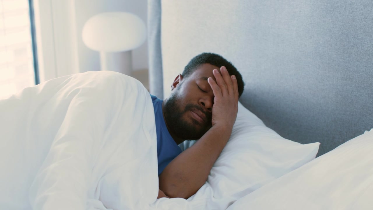Young Man Sleeping Peacefully in Bed at Home