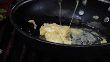 chef melting cheese on a non-stick saucepan