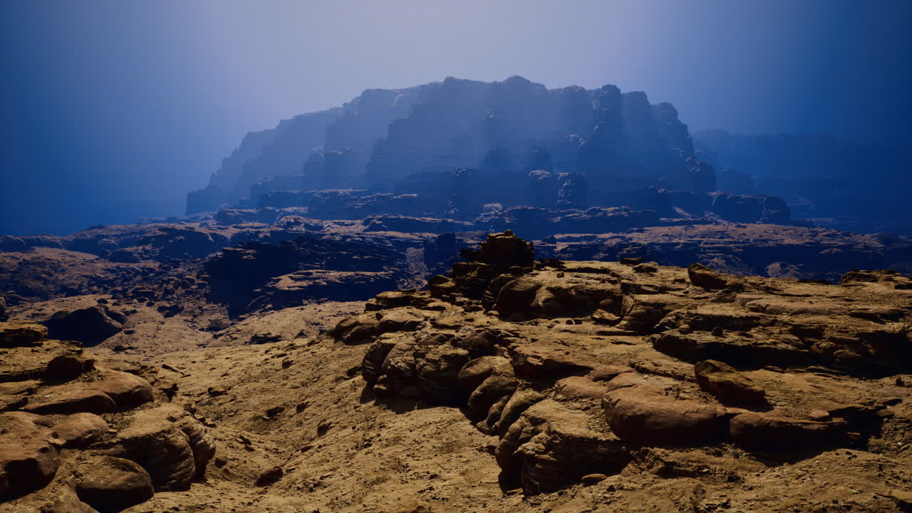 Stunning rocky landscape illuminated by distant mountains in twilight