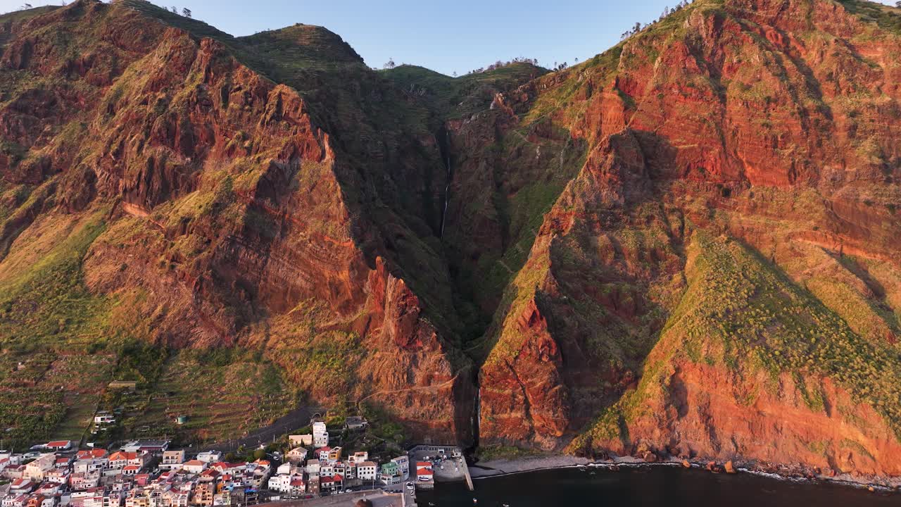 Drone establisher toward Paúl do Mar seaside town and waterfall on Madeira
