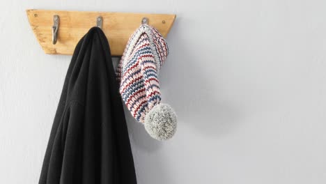 Warm-clothes-hanging-on-hook-4k