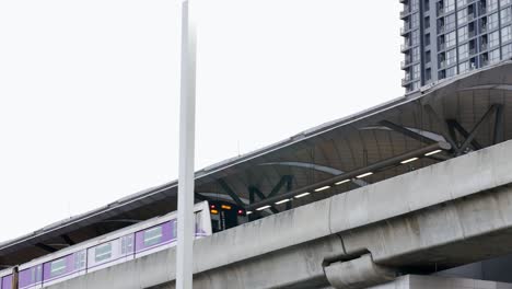 monorail stopping by a train station in the middle of a busy city and a popular tourist destination in southeast asia