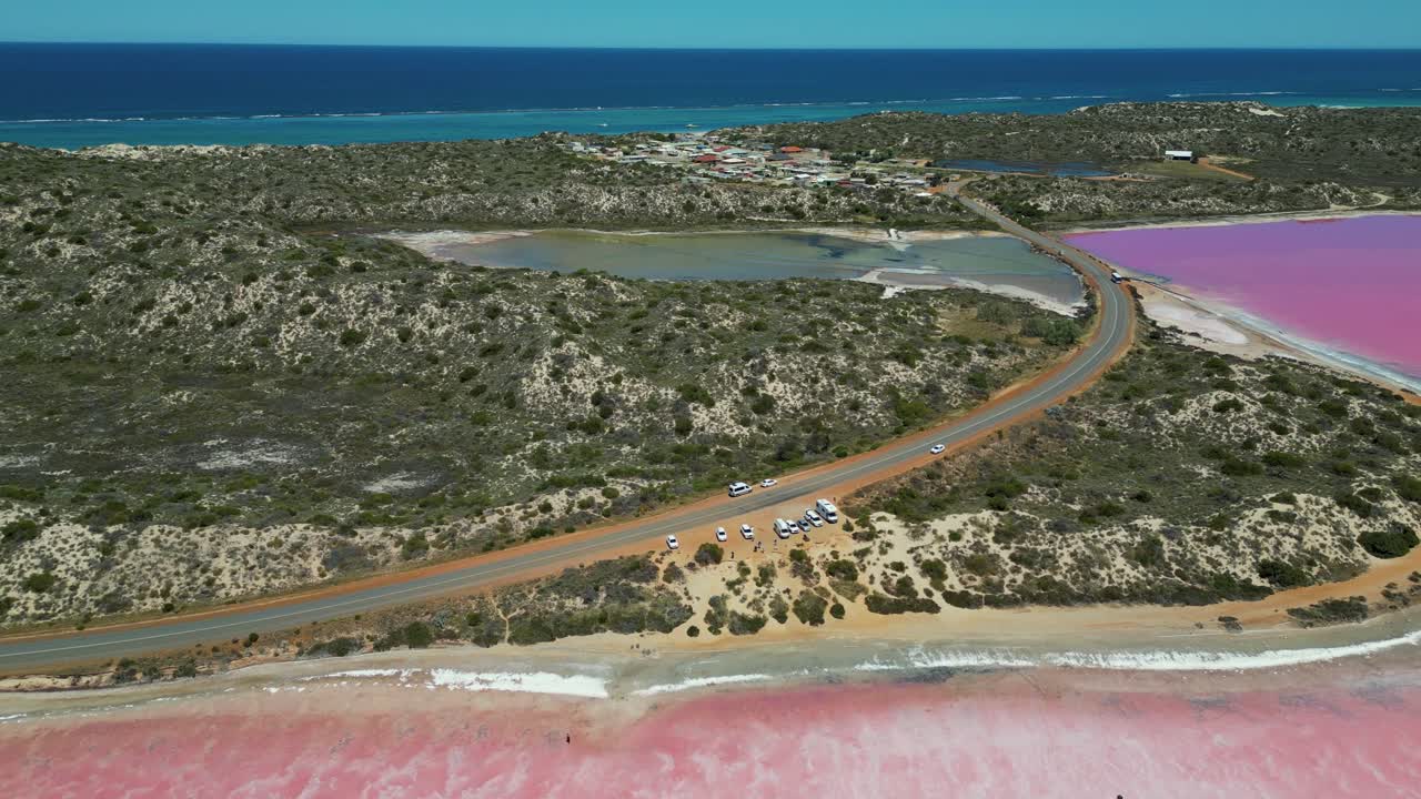 Aerial view looking over the road and shoreline of Pink Lake, Hutt Lagoon, Western Australia