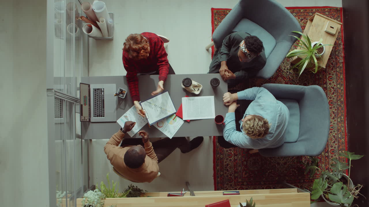 Business Team High Fiving at Office Meeting