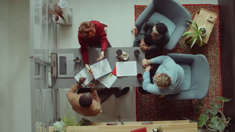 business team high fiving at office meeting