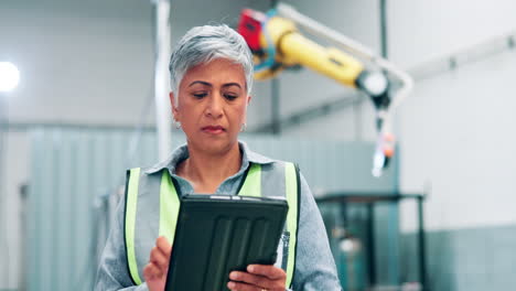 female factory worker using tablet in a modern manufacturing facility