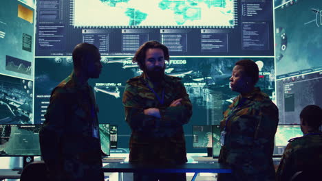 brigadier general and his staff studying radar data on a holographic image