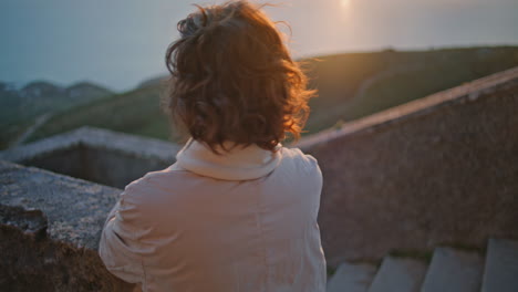 portrait smiling woman sunrise looking calm coastal landscape. elegant traveler