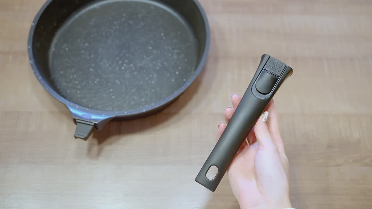 Woman holding a pan handle