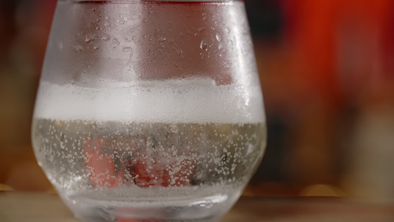 Close-up of a chilled glass of soda with ice
