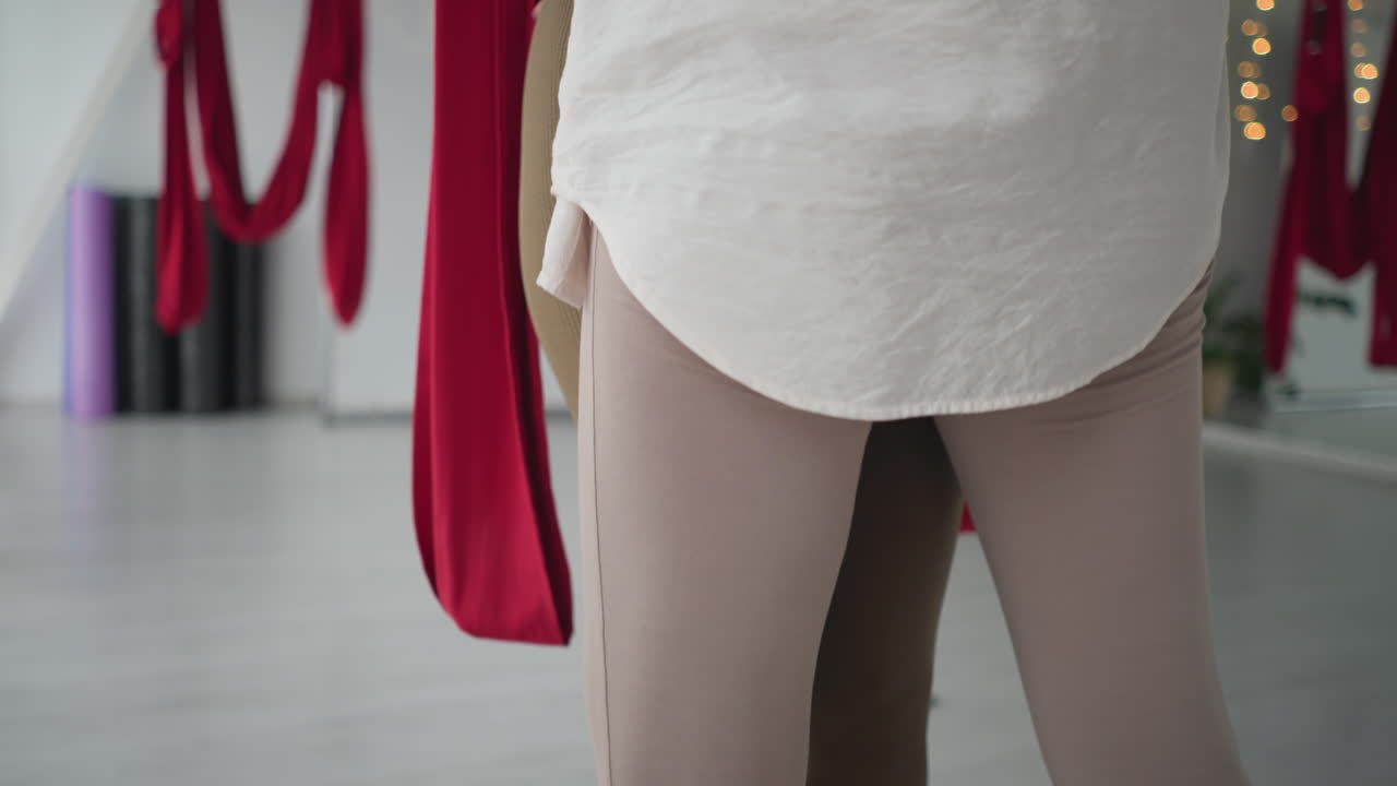 Zen enthusiasts holding each other closely during mindful wellness session, sharing connection and emotional presence in serene studio, silks and soft natural light creating calming atmosphere