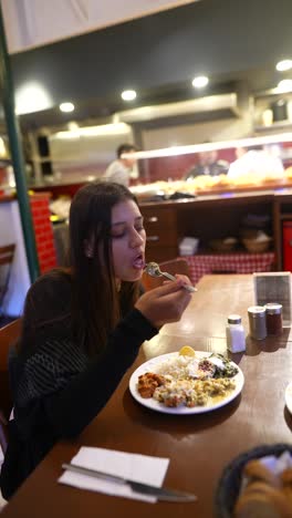 woman eating in a restaurant