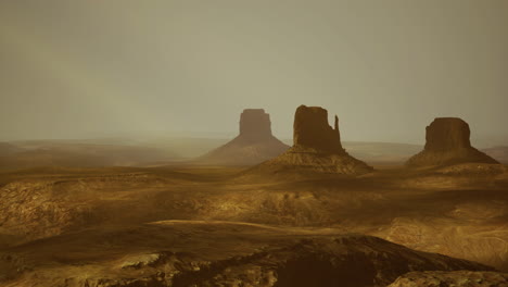 monument valley landscape with rock formations under hazy sky