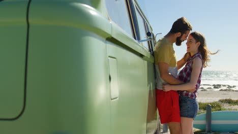 young couple kissing near van on a sunny day 4k