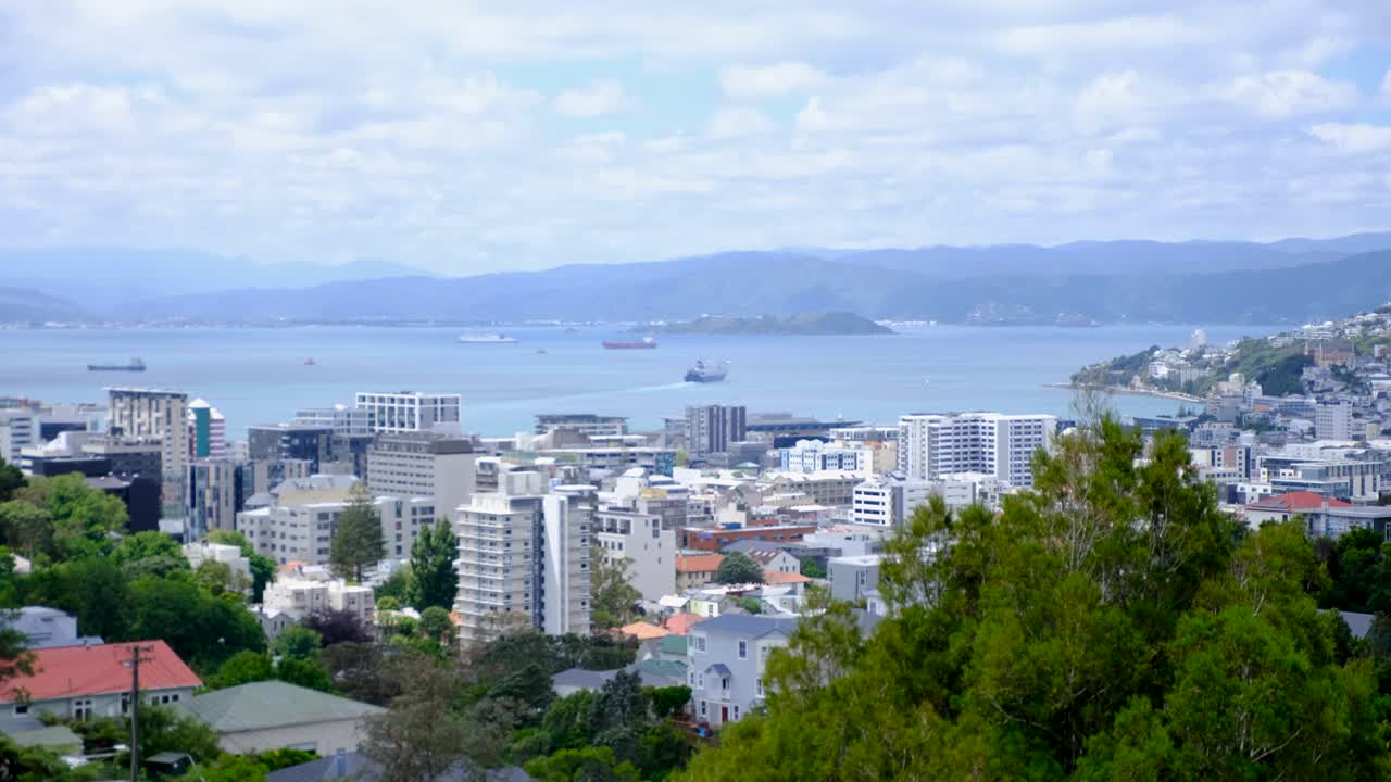 Aerial view of Wellington city with skyscraper office buildings and ferry leaving harbour in capital city of New Zealand Aotearoa