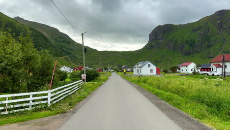 Empty-street-in-Unstad-during-summer-with-seagull-flying-over-the-village