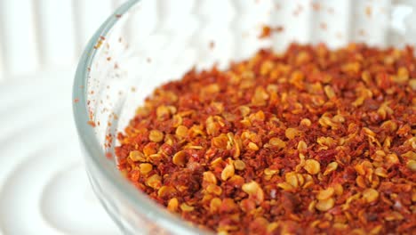 dried red chili flakes in glass bowl