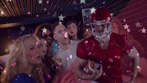 animation of stars and american football player over happy diverse group of friends drinking in bar