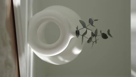 minimalist white vase with eucalyptus branches