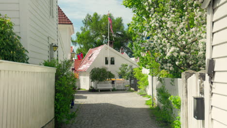 old cozy white houses in a cozy alley in sandviken, bergen