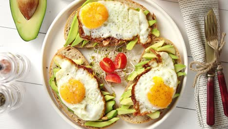 delicious healthy breakfast with sliced avocado sandwiches with fried egg