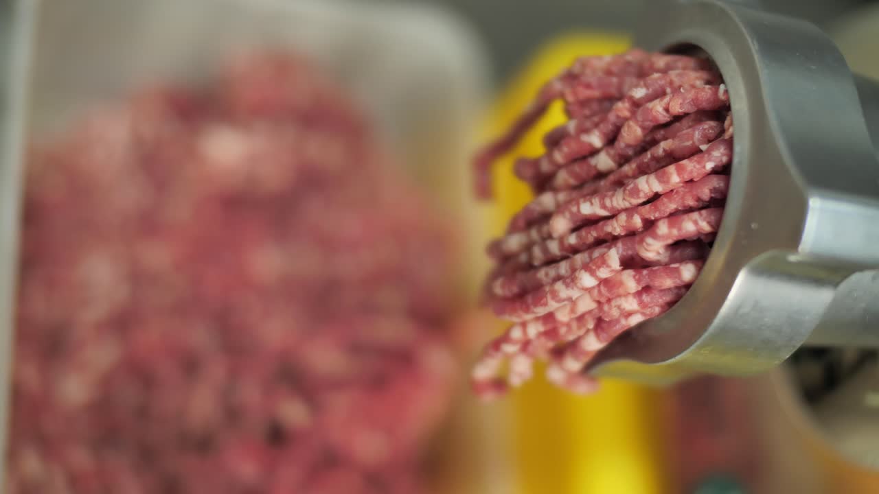 Mincing meat on grinding machine, close up