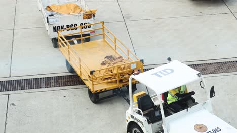 tug vehicle transporting cargo at airport