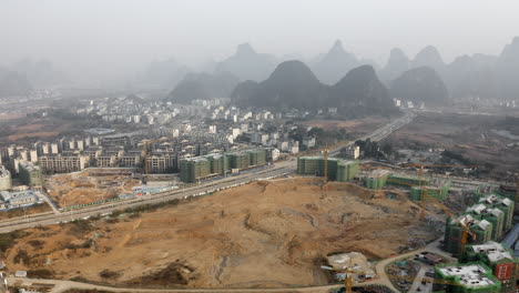 large city building construction site, yangshuo china development, aerial view