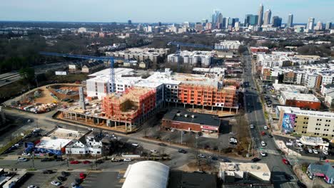 charlotte nc plaza midwood construction aerial orbit with skyline in view