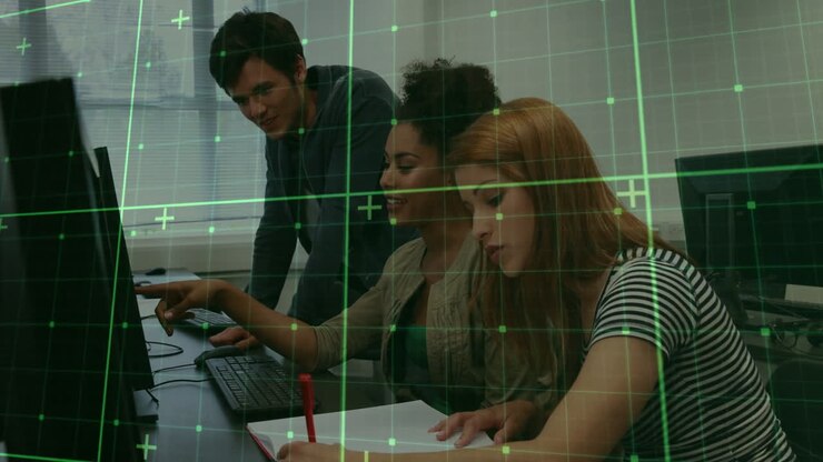 Three people collaborating at computers with digital grid overlay animation
