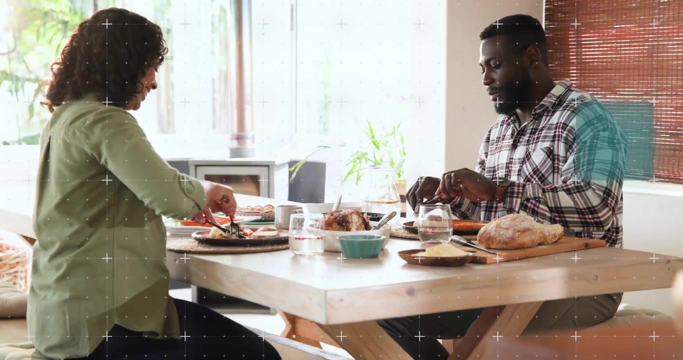 Woman picking knife and slicing veggies, man serving meat with glitch flickering during shared meal